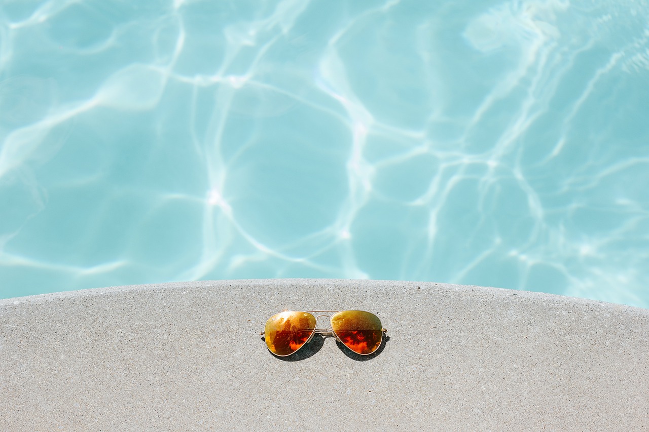 A pair of sunglasses sitting by a Las Vegas pool in the hot summer.