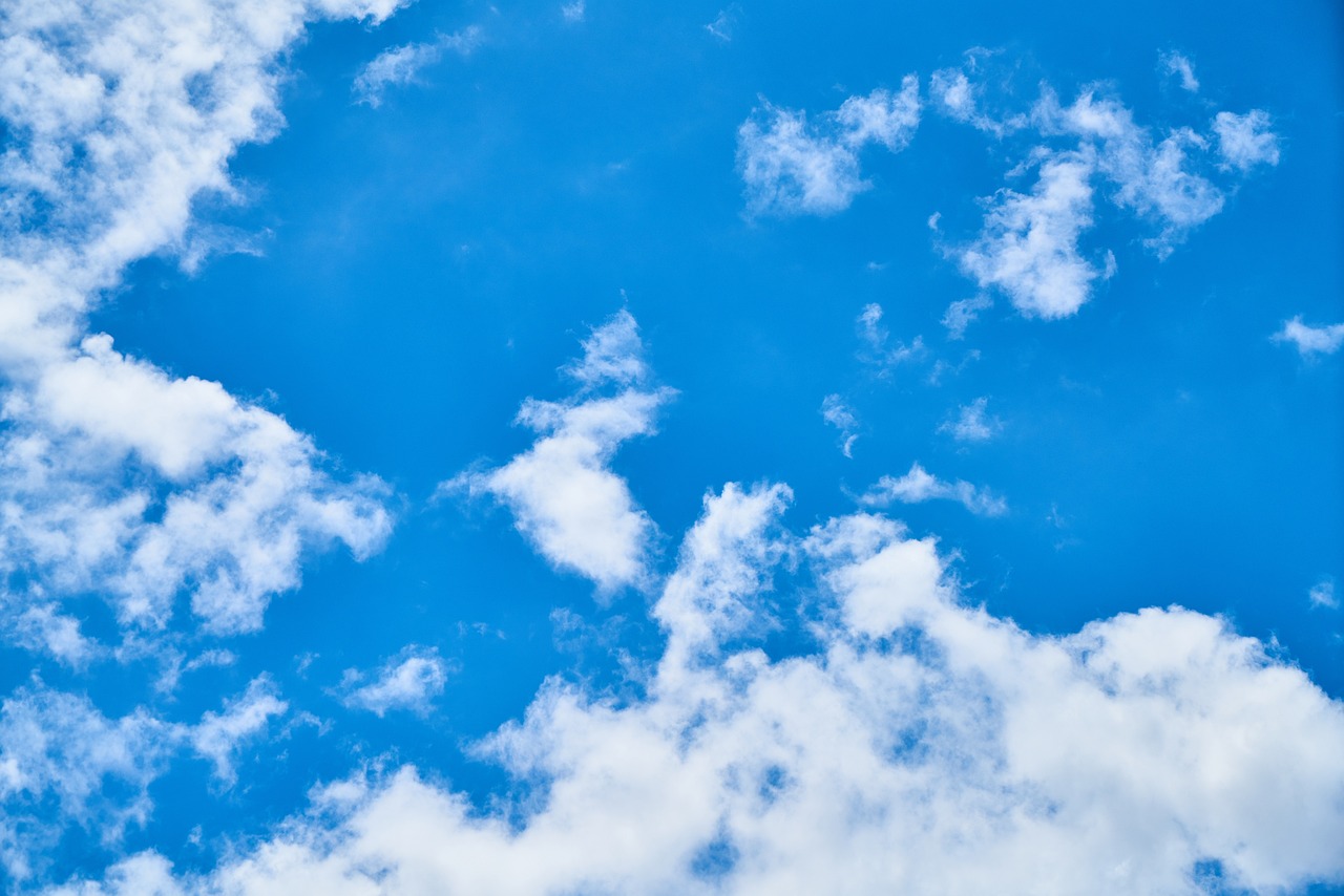 A blue sky with some clouds, representing clean air quality.